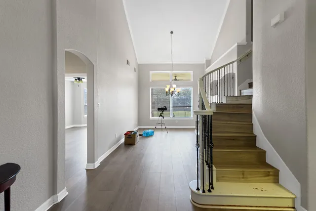 a view of entryway and hall with wooden floor