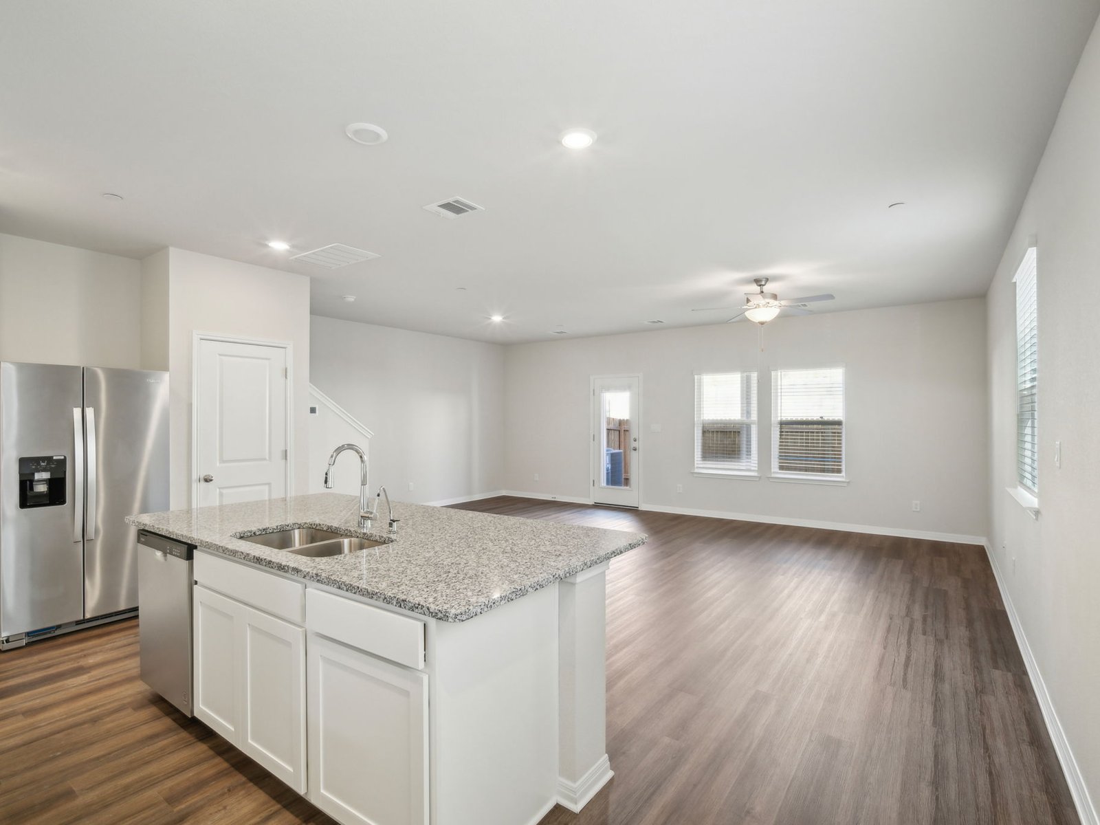 165 Calcite Road, Unit 3 Kyle, TX 78640 - Photo 7 of 17 a kitchen with stainless steel appliances granite countertop a sink and dishwasher with wooden floor