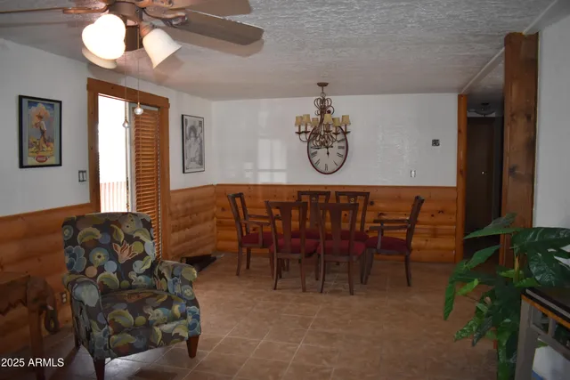 a view of a dining room with furniture and a chandelier