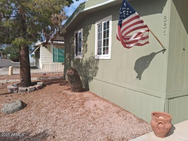 a porch with wooden floor in front of house