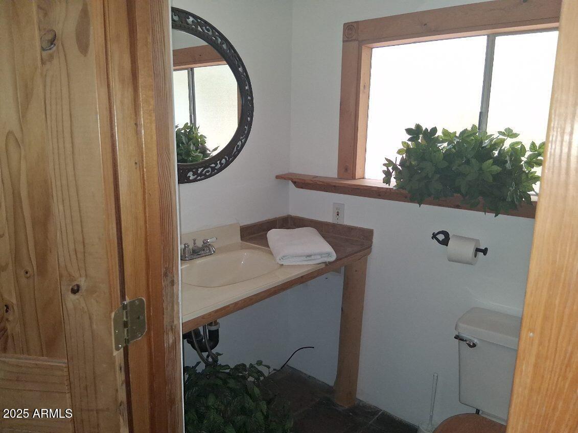 201 South Greenfield Road, Unit 331 Mesa, AZ 85206 - Photo 42 of 49 a bathroom with a sink and a mirror