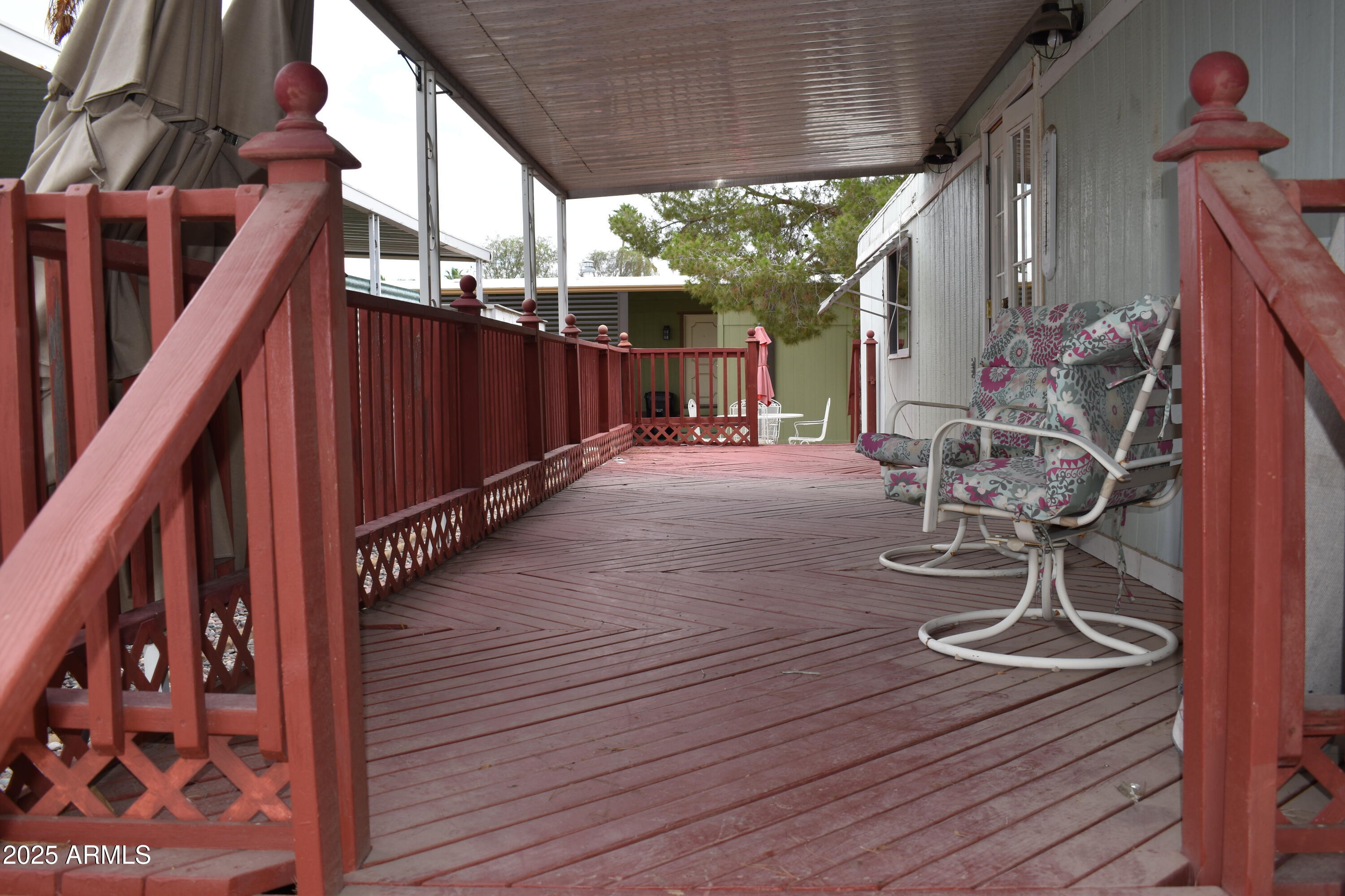 201 South Greenfield Road, Unit 331 Mesa, AZ 85206 - Photo 6 of 49 a view of backyard with wooden floor and iron fence