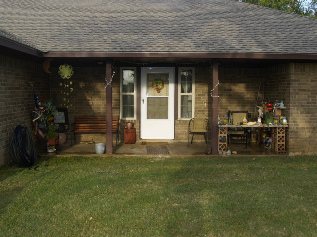 750 Oil Field Road Lockhart, TX 78644 - Photo 1 of 1 a view of a house with backyard and porch