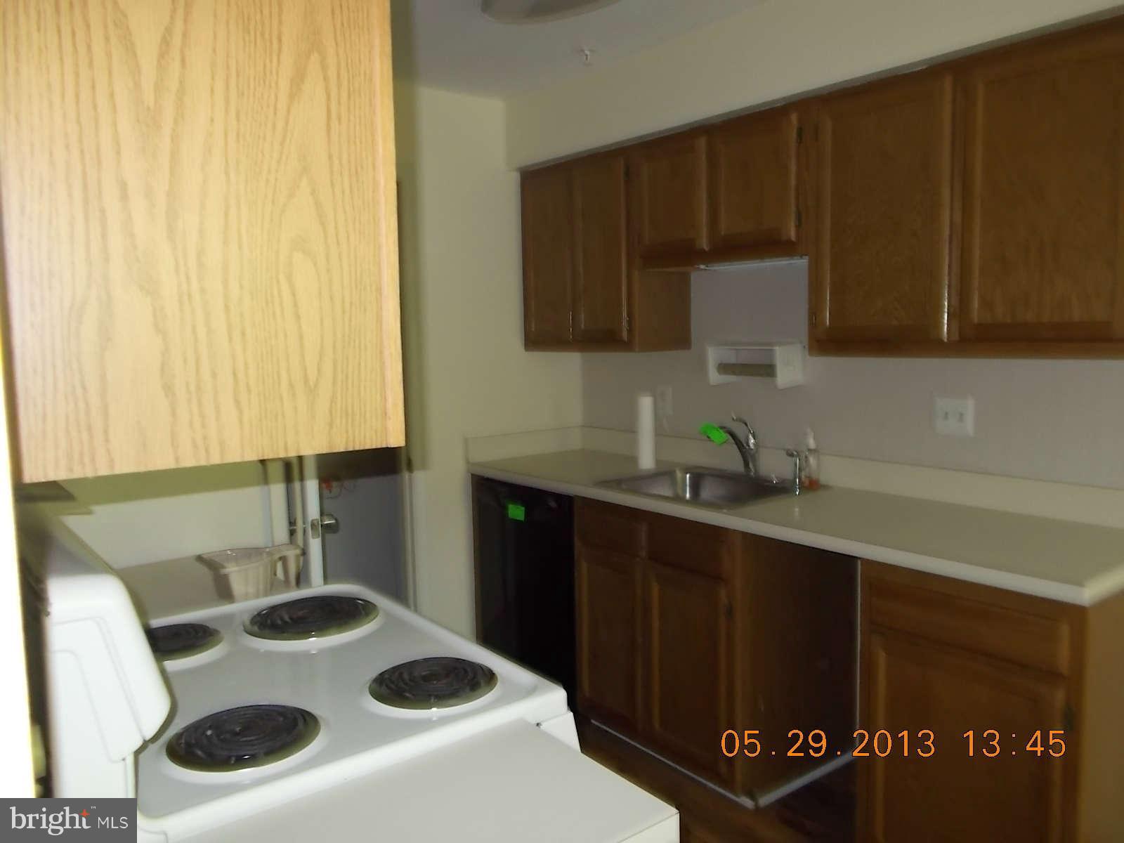 14913 Cleese Court, Unit C Silver Spring, MD 20906 - Photo 11 of 20 a kitchen with a sink a stove and cabinets
