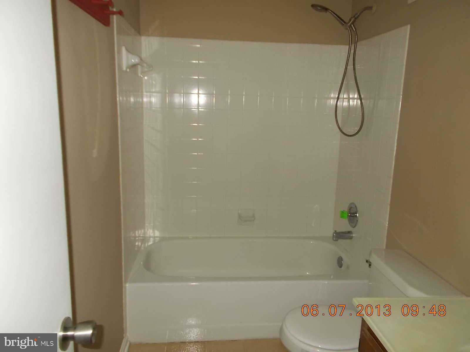 14913 Cleese Court, Unit C Silver Spring, MD 20906 - Photo 15 of 20 a bathroom with a bath tub with a shower