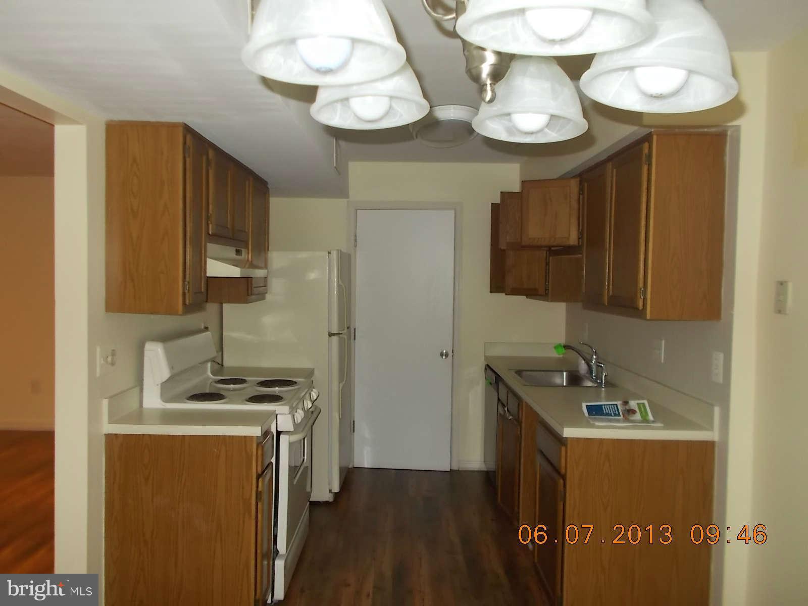 14913 Cleese Court, Unit C Silver Spring, MD 20906 - Photo 9 of 20 a kitchen that has a lot of cabinets