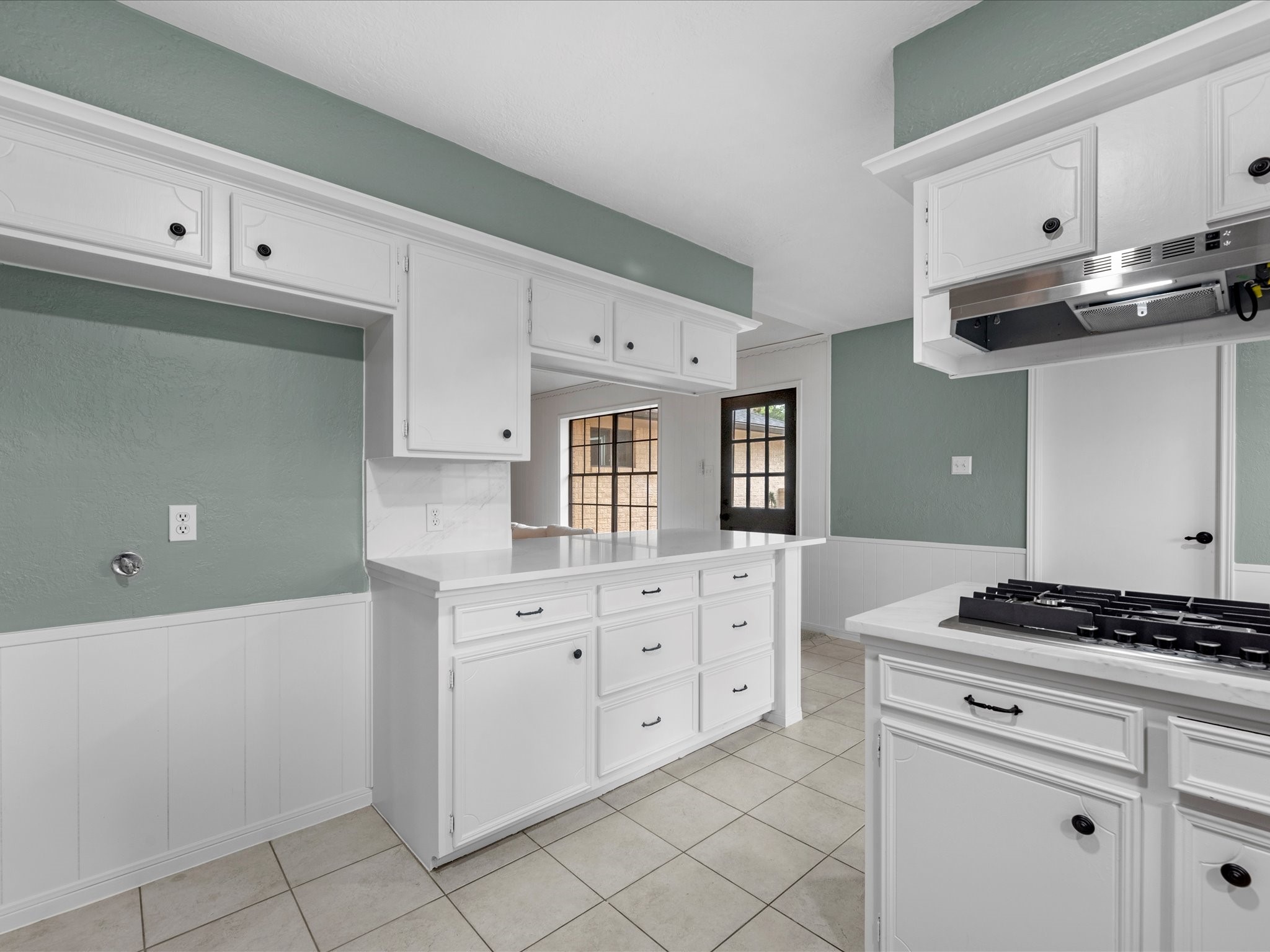 4002 Cujanes Street Pasadena, TX 77504 - Photo 10 of 26 a kitchen with granite countertop white cabinets and white appliances