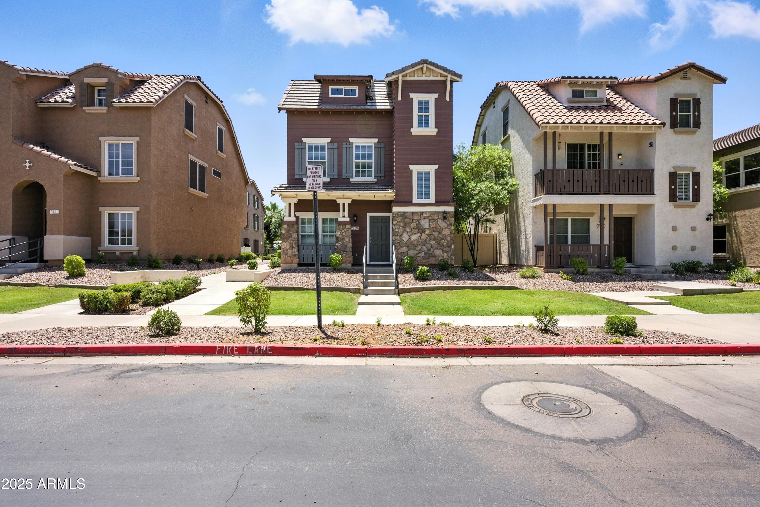 a view of building with yard and traffic signal