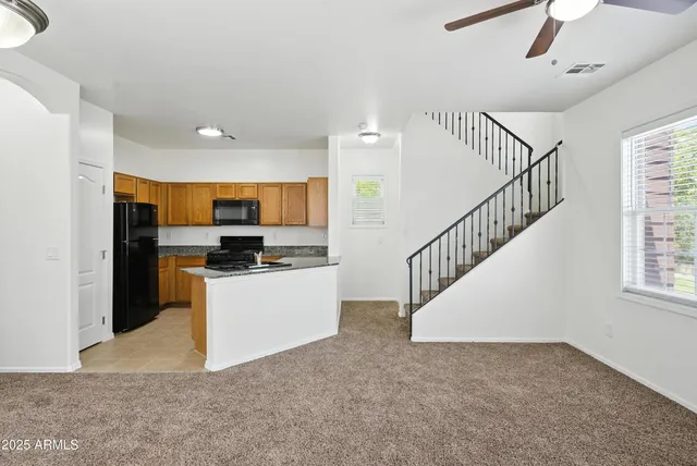 a kitchen with stainless steel appliances a refrigerator and a stove top oven
