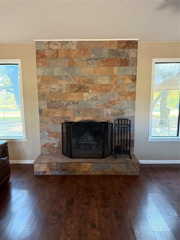401 Highway 2247 Comanche, TX 76442 - Photo 7 of 19 an empty room with wooden floor and a fireplace