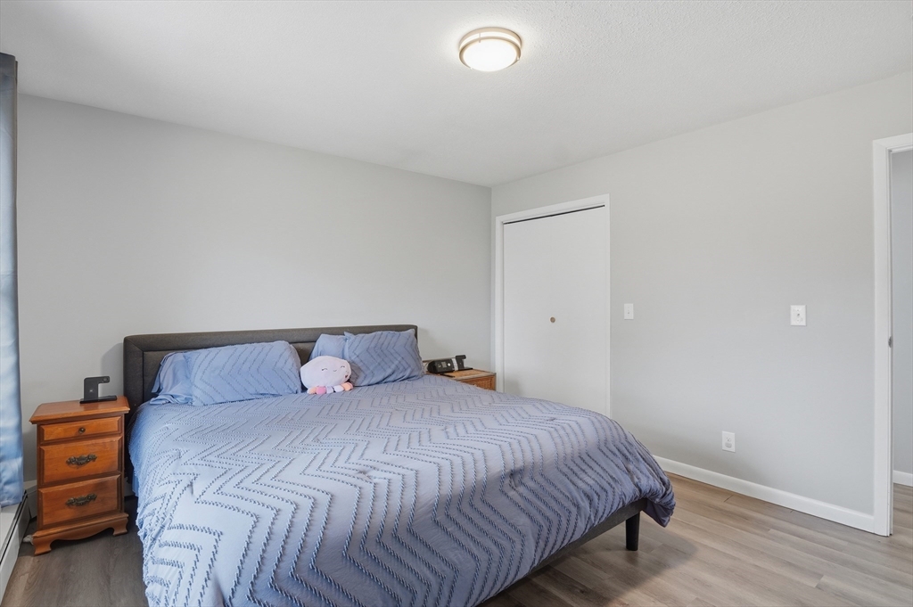 185 Davis Road Westminster, MA 01473 - Photo 15 of 36 a bedroom with a bed and wooden floor