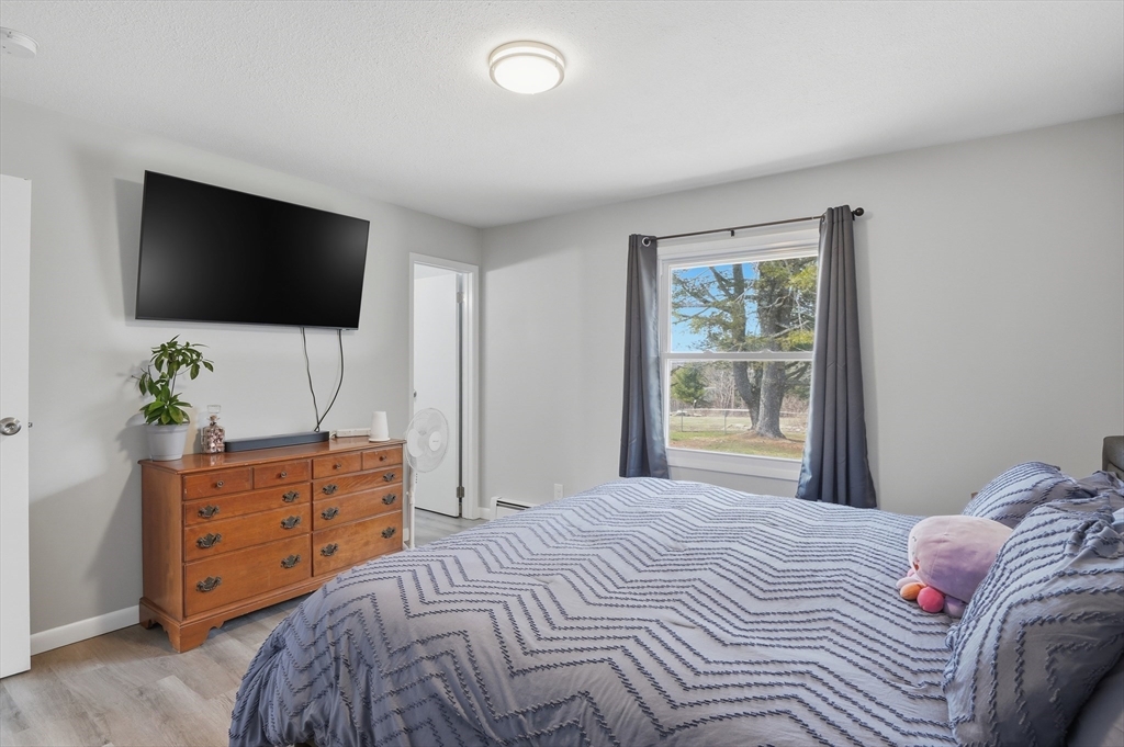 185 Davis Road Westminster, MA 01473 - Photo 16 of 36 a bedroom with a bed and a flat screen tv
