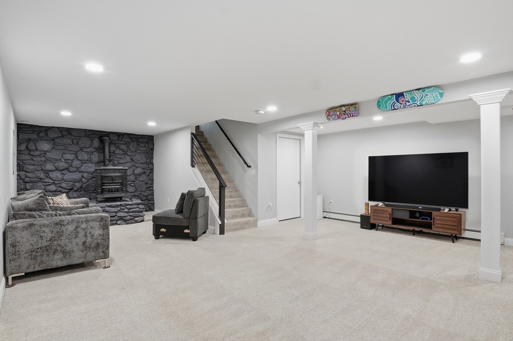 185 Davis Road Westminster, MA 01473 - Photo 23 of 36 a living room with furniture and a flat screen tv