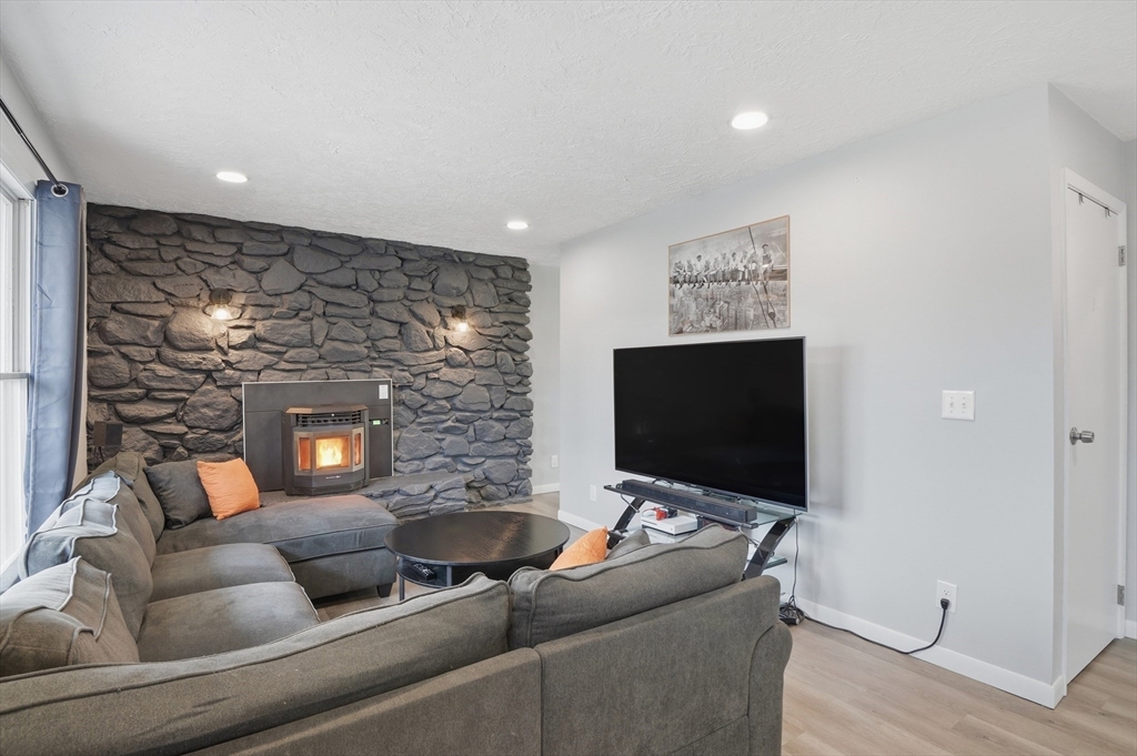 185 Davis Road Westminster, MA 01473 - Photo 3 of 36 a living room with furniture and a flat screen tv