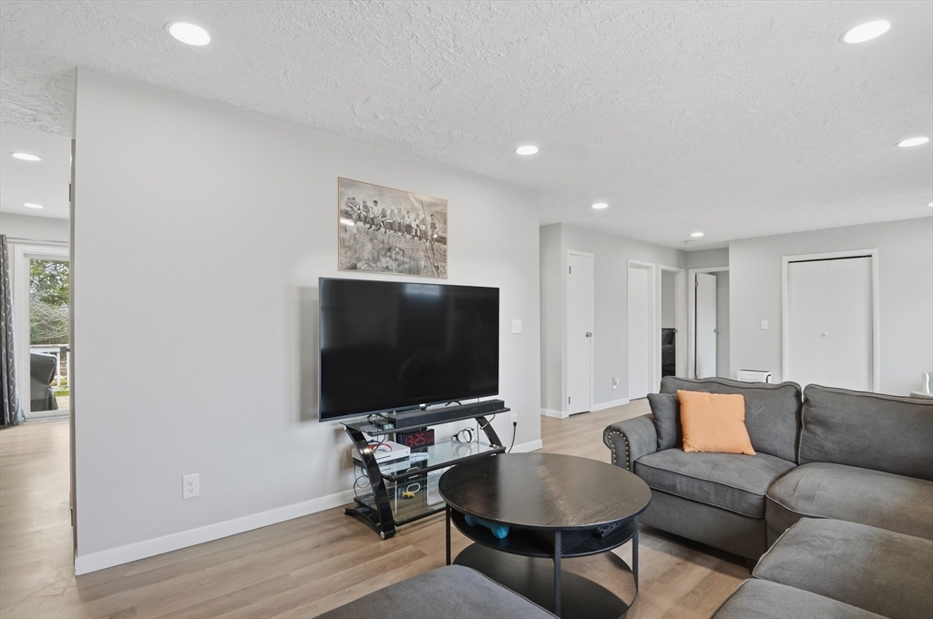 185 Davis Road Westminster, MA 01473 - Photo 6 of 36 a living room with furniture and a flat screen tv