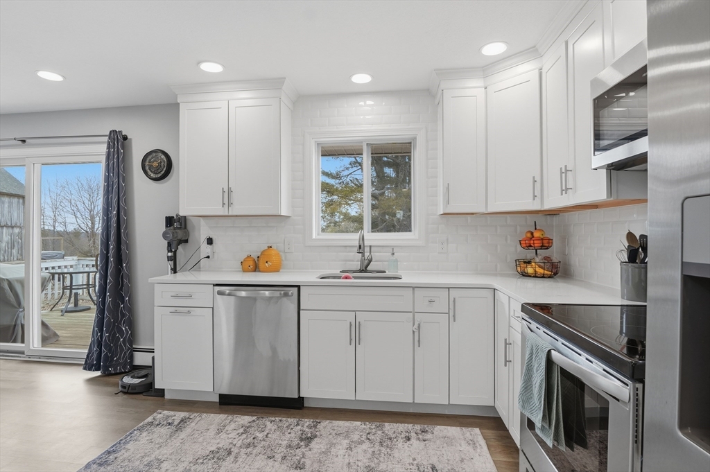 185 Davis Road Westminster, MA 01473 - Photo 7 of 36 a kitchen with stainless steel appliances granite countertop a sink stove and refrigerator