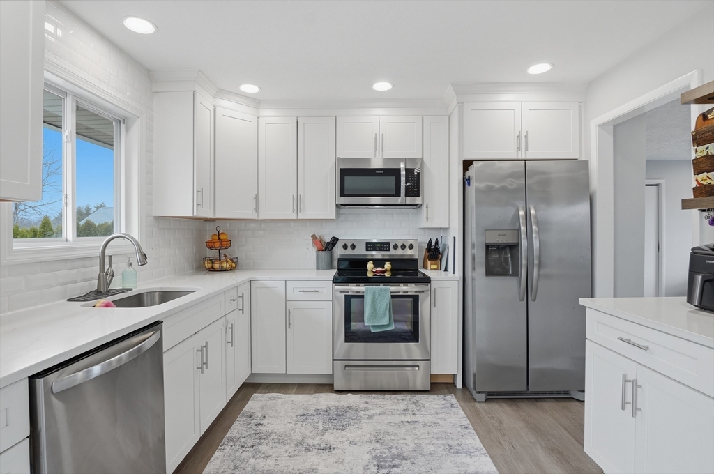 185 Davis Road Westminster, MA 01473 - Photo 9 of 36 a kitchen with a refrigerator sink and cabinets