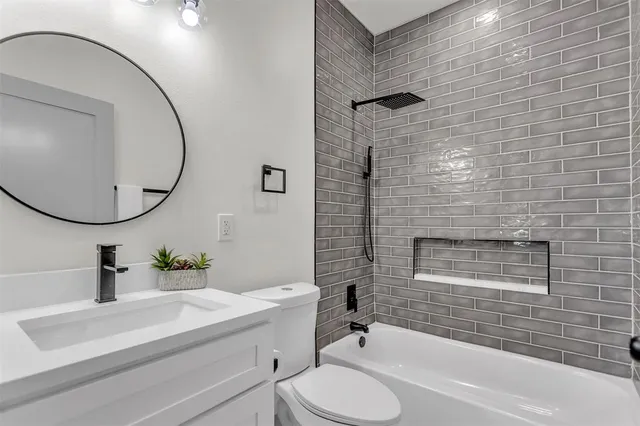 a bathroom with a sink a toilet and a mirror