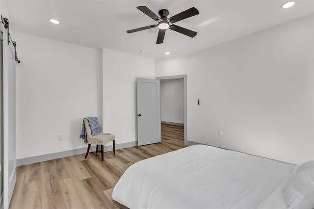 a bedroom with a bed and a chair