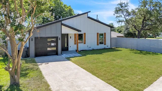 a front view of house with a garden
