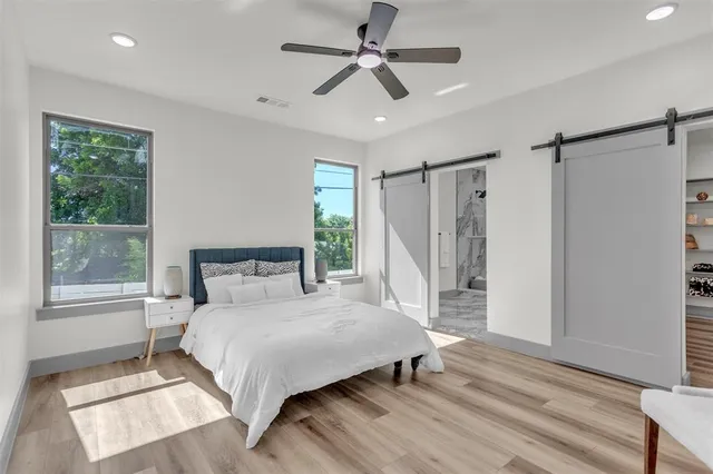 a bedroom with a bed closet and a window