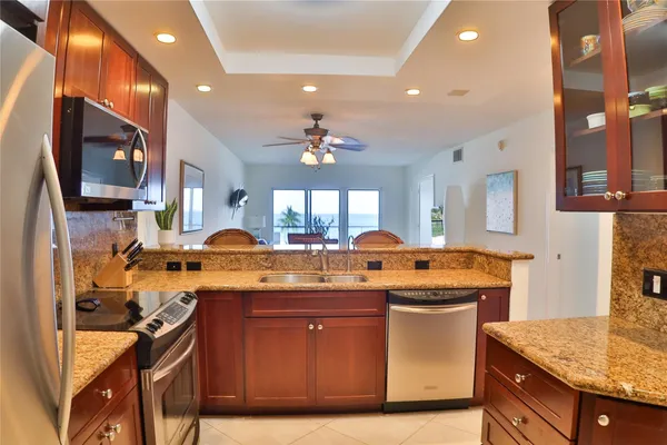 a kitchen with a stove and a wooden floor