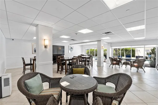 a dining room with furniture a table and kitchen view