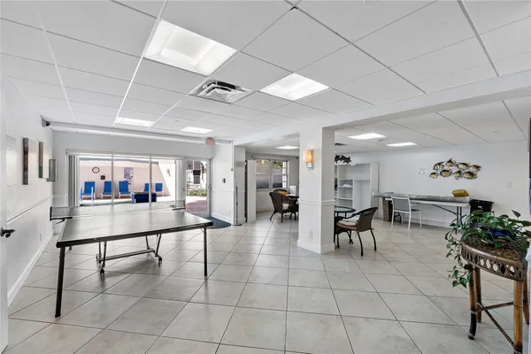 a living room with furniture a dining table and a potted plant