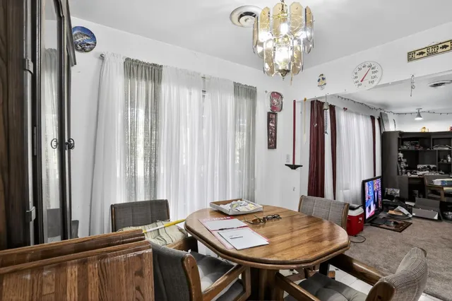 a view of a dining room with furniture and window