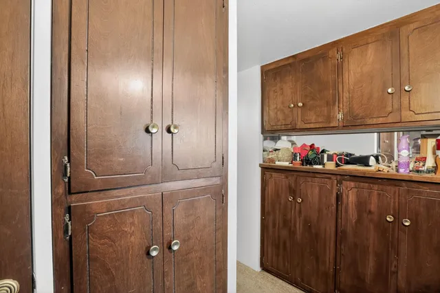 a kitchen with a refrigerator and cabinets