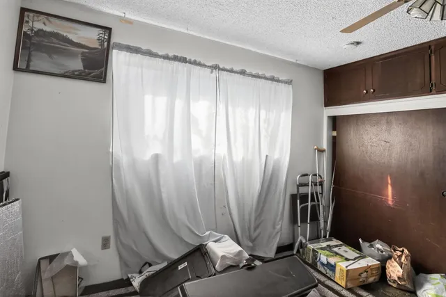 a view of a room with wooden floor and windows