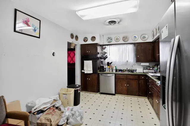 a kitchen with stainless steel appliances kitchen island granite countertop a refrigerator and a stove