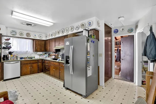 a kitchen with stainless steel appliances granite countertop a refrigerator and a sink