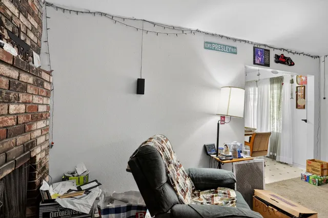 a living room with furniture and a lamp