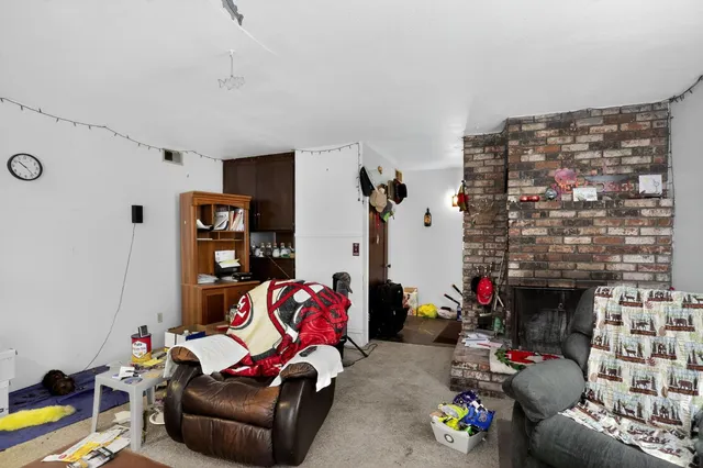 a living room with furniture a rug and a fireplace