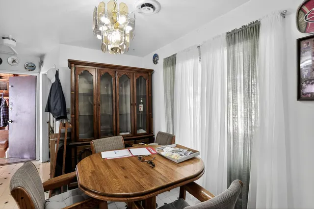 a view of a dining room with furniture and window
