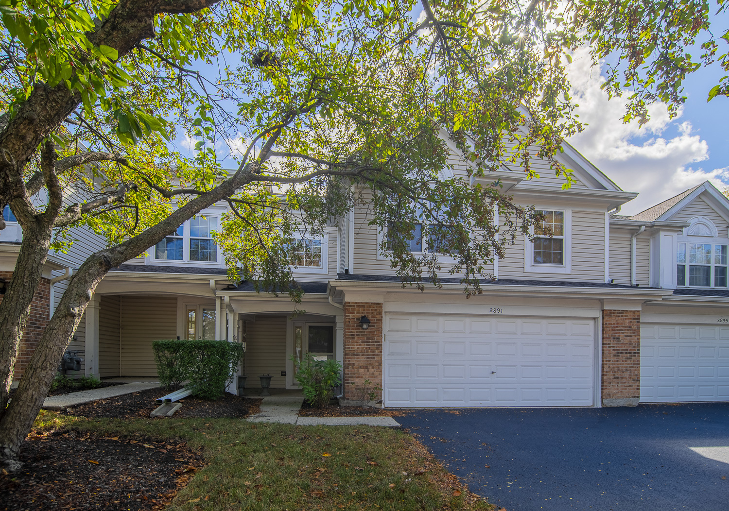2891 Belle Lane, Unit 2891 Schaumburg, IL 60193 - Photo 1 of 25 a front view of a house with a garden