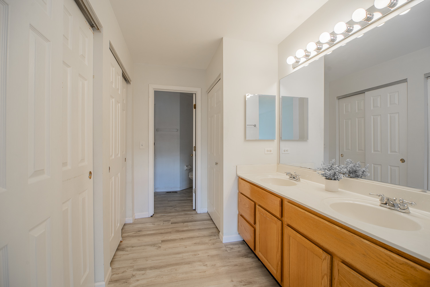 2891 Belle Lane, Unit 2891 Schaumburg, IL 60193 - Photo 18 of 25 a bathroom with a double vanity sink and a mirror