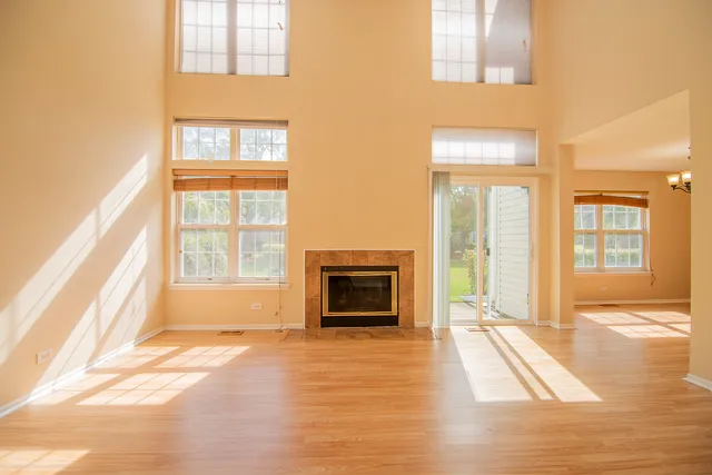 a view of an empty room with window and fire place