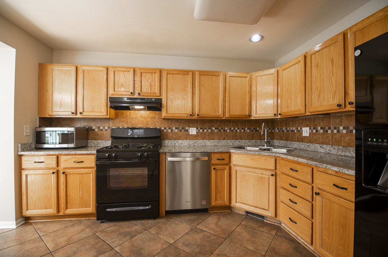 2891 Belle Lane, Unit 2891 Schaumburg, IL 60193 - Photo 8 of 25 a kitchen with granite countertop white cabinets sink and stainless steel appliances