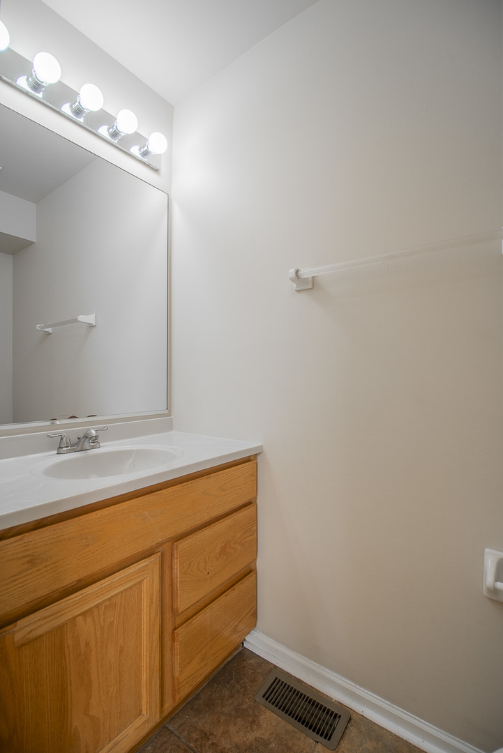 2891 Belle Lane, Unit 2891 Schaumburg, IL 60193 - Photo 9 of 25 a bathroom with a sink and a mirror