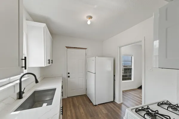 a bath tub sitting next to a white sink