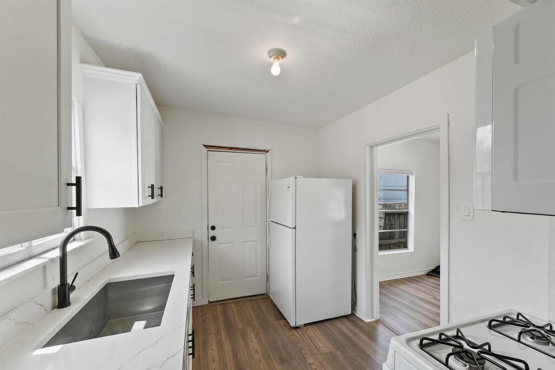 3019 Florida Street, Unit 3 Houston, TX 77026 - Photo 11 of 14 a kitchen with a refrigerator sink and cabinets
