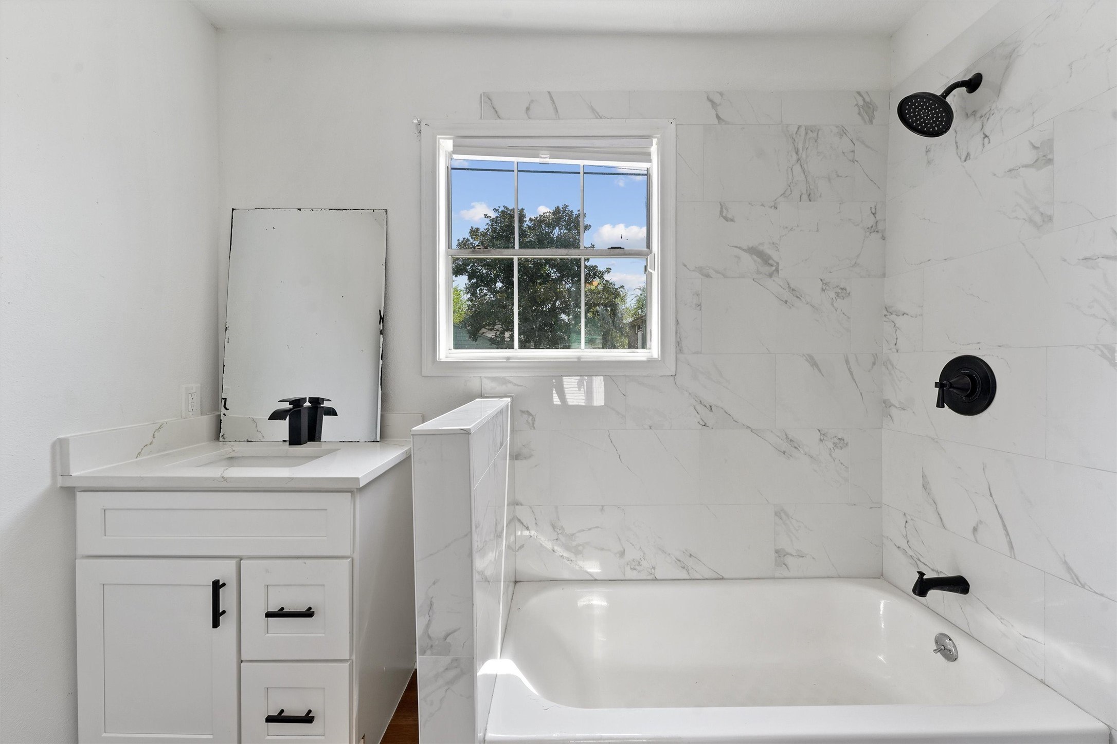 3019 Florida Street, Unit 3 Houston, TX 77026 - Photo 12 of 14 a bath tub sitting next to a white sink