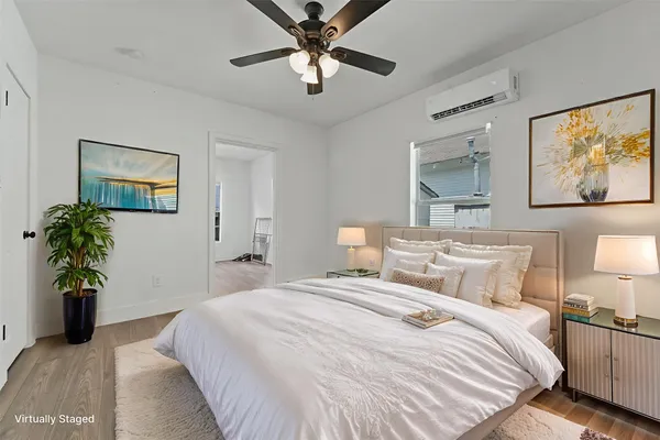 a bedroom with a balcony a bed and a chandelier