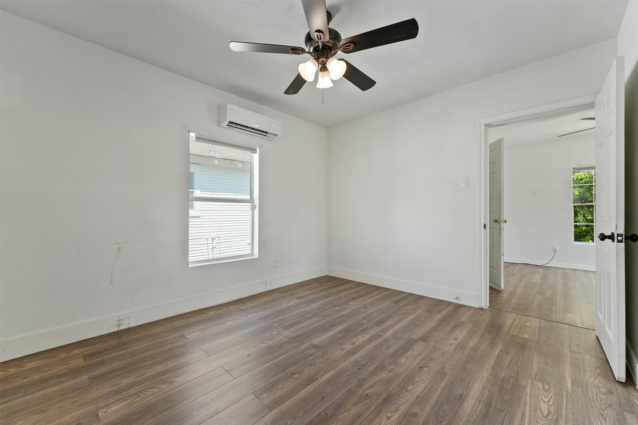3019 Florida Street, Unit 3 Houston, TX 77026 - Photo 8 of 14 wooden floor in an empty room with a window