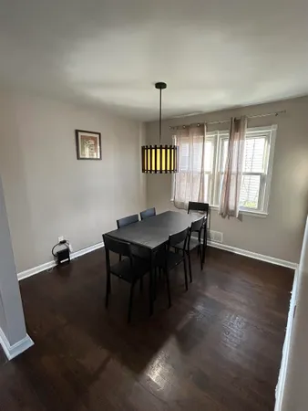 an empty room with a table and chairs