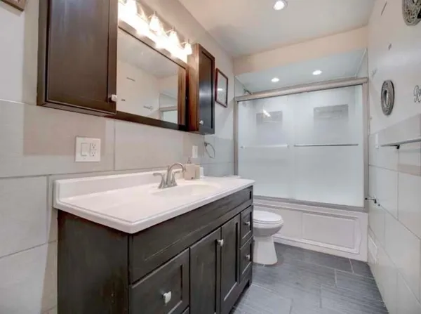 a bathroom with a sink toilet and shower