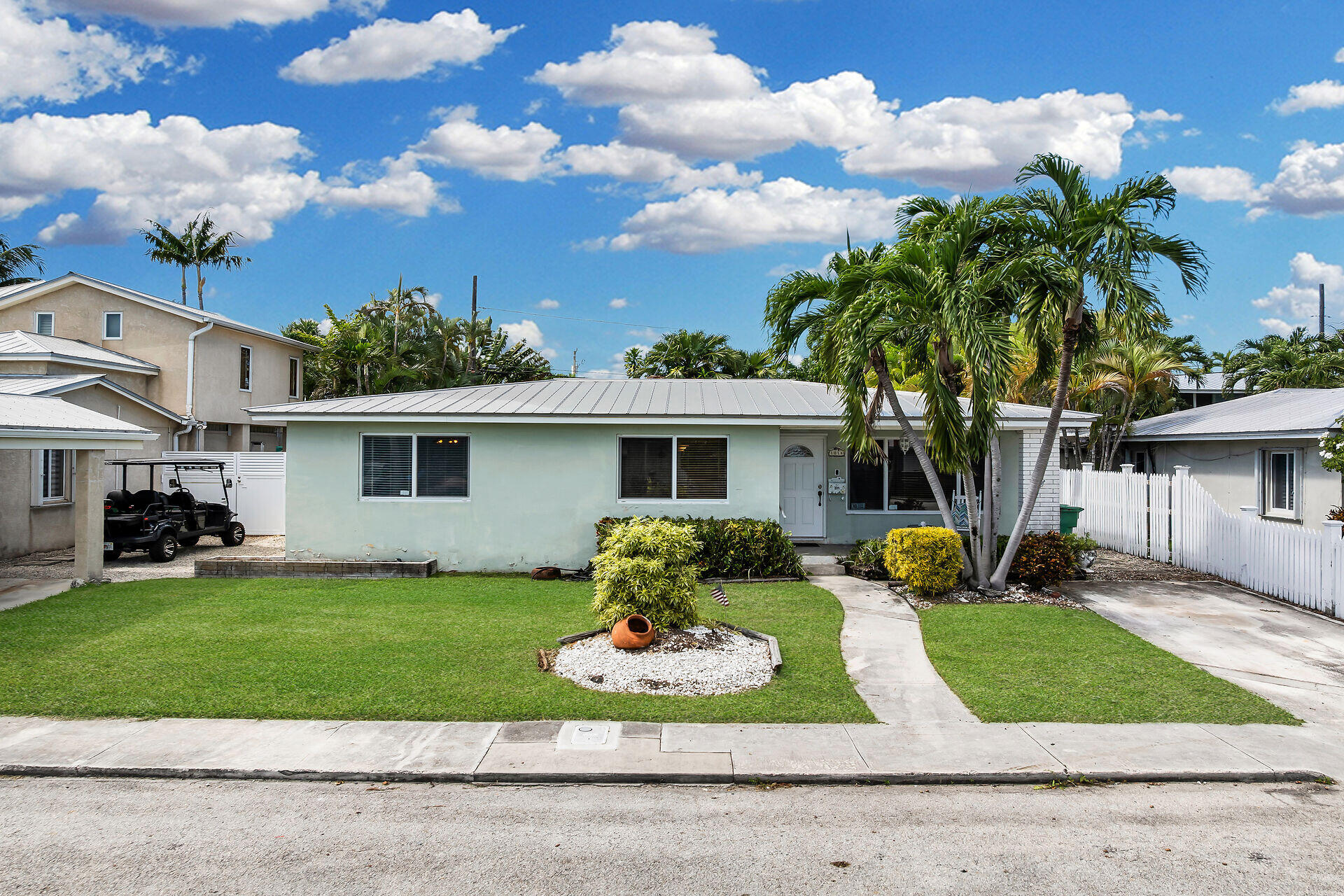 1014 17th Terrace Key West, FL 33040 - Photo 2 of 32 a front view of a house with a yard and garage