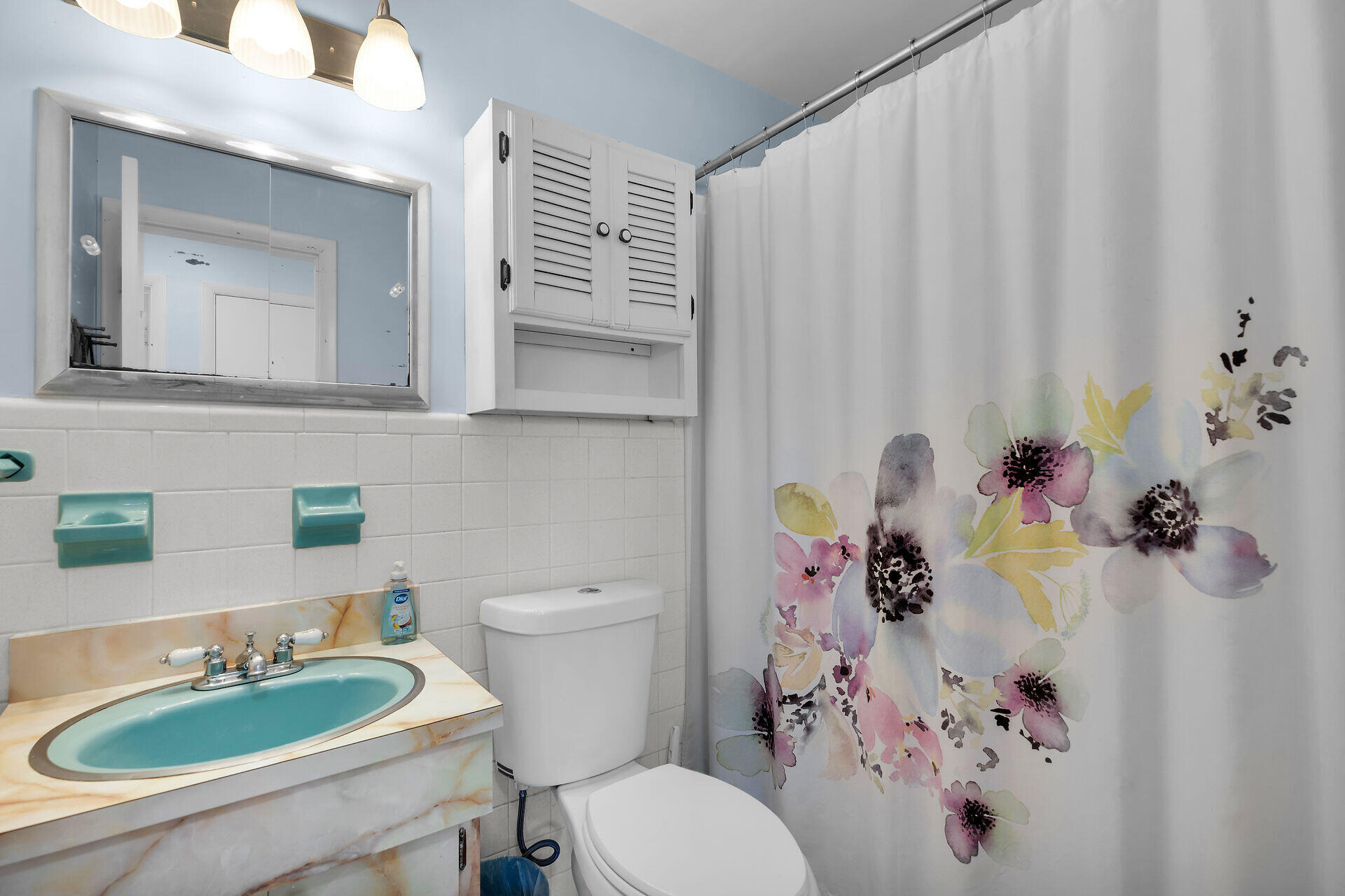 1014 17th Terrace Key West, FL 33040 - Photo 29 of 32 a bathroom with a sink a toilet and shower curtain